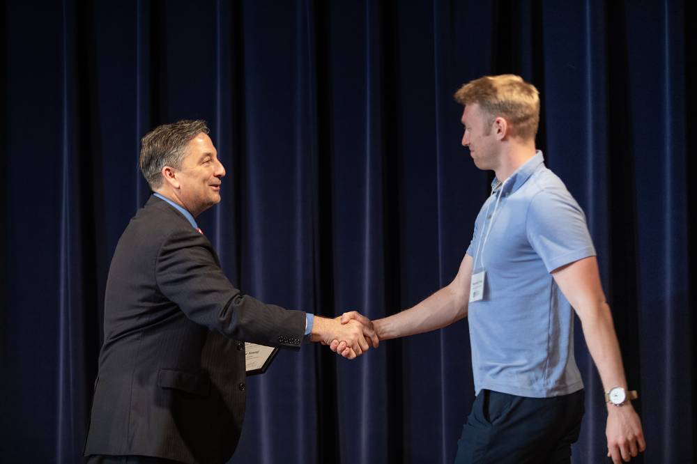 Maximillian Young shaking hands with Dr. Smart.